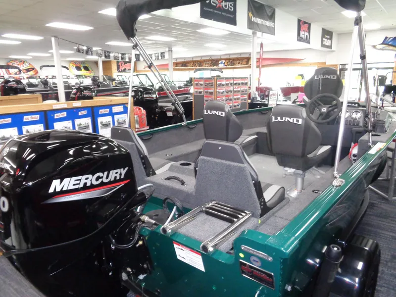 Slide: The Image of 2025 Lund 1650 Rebel XL SS boat with Mercury engine displayed in showroom. - 17