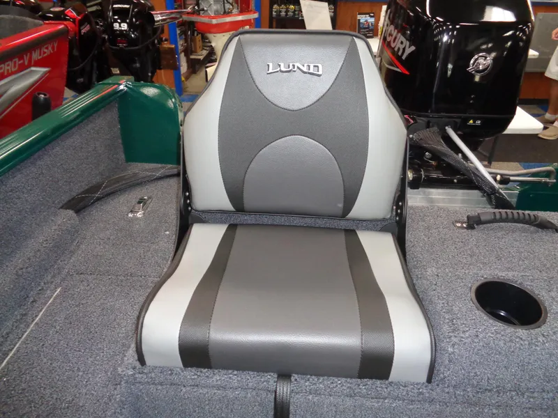 Slide: The Image of 2025 Lund 1650 Rebel XL SS boat seat, gray and black design, in showroom setting. - 6