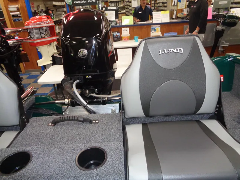 Slide: The Image of 2025 Lund 1650 Rebel XL SS boat interior with Mercury engine in showroom. - 7