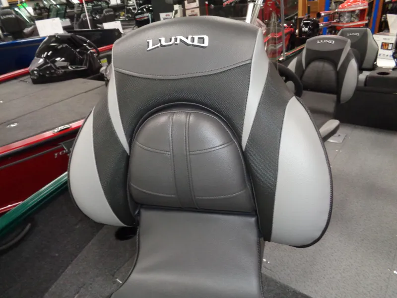 Slide: The Image of 2025 Lund 1650 Rebel XL SS boat seat, black and gray design, showroom display. - 9