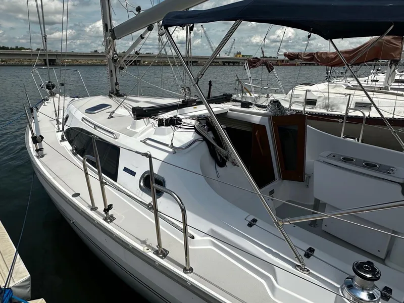 The Image of Sailboat Catalina 315, 2017 model, docked at marina under cloudy sky. - 0