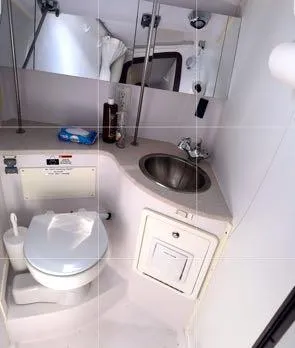 Slide: The Image of 2017 Catalina 315 yacht bathroom with sink, toilet, and mirror. - 13