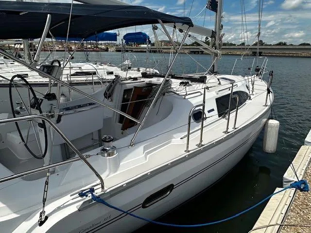 Slide: The Image of 2017 Catalina 315 sailboat docked at marina under blue sky. - 3