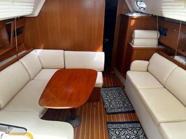 Slide: The Image of 2017 Catalina 315 yacht interior with wooden table, cream seating, and elegant decor. - 7