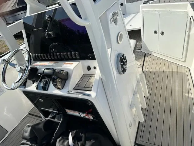 Slide: The Image of 2022 Yamaha Boats 255 FSH Sport E cockpit with steering wheel and control panel. - 12
