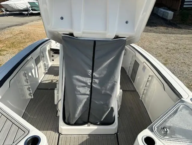 Slide: The Image of 2022 Yamaha Boats 255 FSH Sport E interior with open storage compartment. - 16