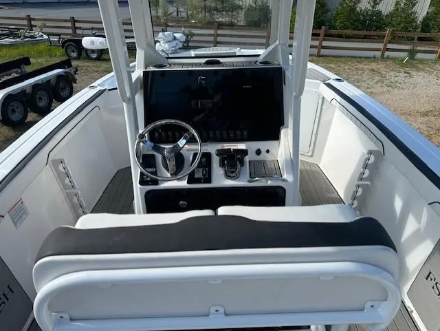 Slide: The Image of 2022 Yamaha Boats 255 FSH Sport E cockpit with steering wheel and control panel. - 5
