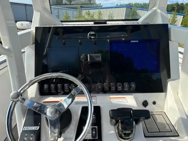 Slide: The Image of Yamaha Boats 2022 255 FSH Sport E dashboard with steering wheel and control panel. - 6