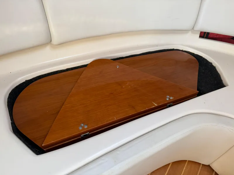 Slide: The Image of 2005 Regal 3350 Sport Cruiser interior with wooden storage compartment. - 12