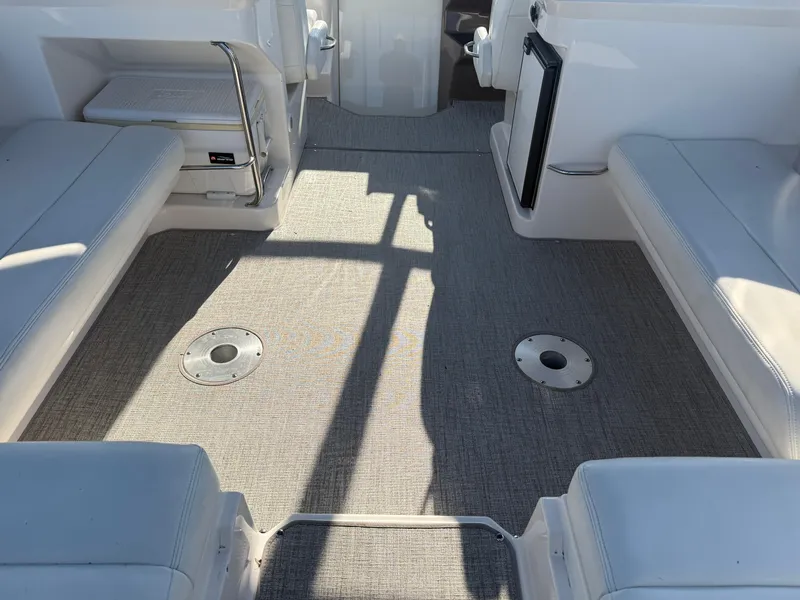 Slide: The Image of 2005 Regal 3350 Sport Cruiser interior with gray carpet and white seating. - 13