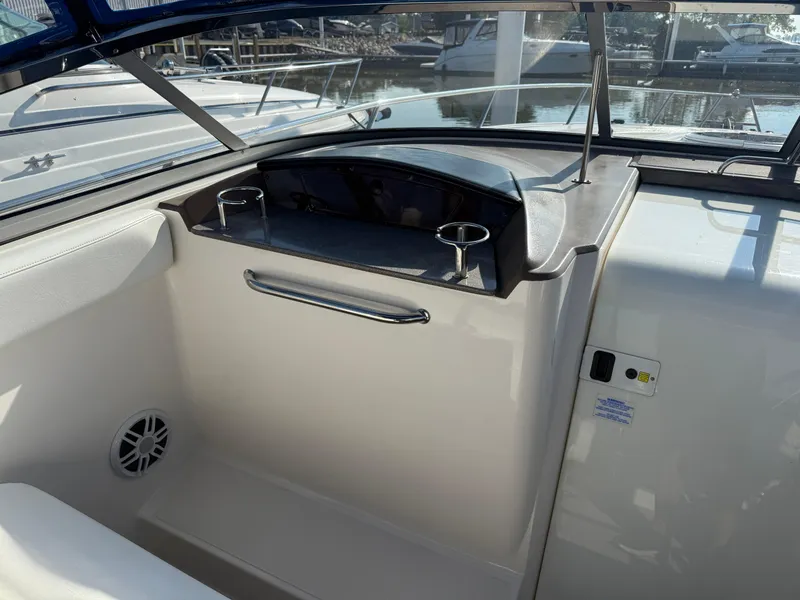 Slide: The Image of 2005 Regal 3350 Sport Cruiser interior with cup holders and sleek dashboard design. - 14