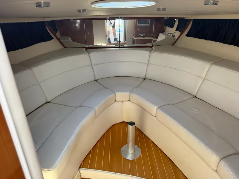 Slide: The Image of 2005 Regal 3350 Sport Cruiser interior with white leather seating and wooden flooring. - 4