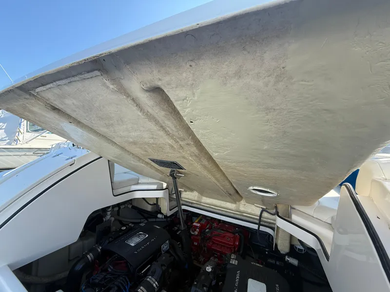 Slide: The Image of Open engine compartment of 2005 Regal 3350 Sport Cruiser boat, showcasing engine details. - 9