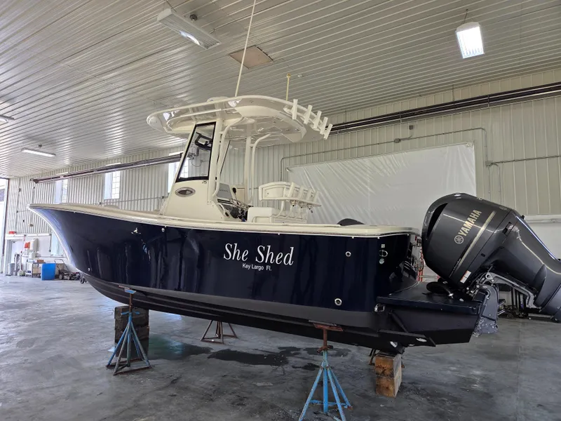 Slide: The Image of 2020 Regulator 25 boat named "She Shed" in a garage, Key Largo, FL. - 1