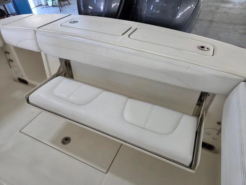 Slide: The Image of 2020 Regulator 25 boat with fold-down white seat and storage compartment. - 11