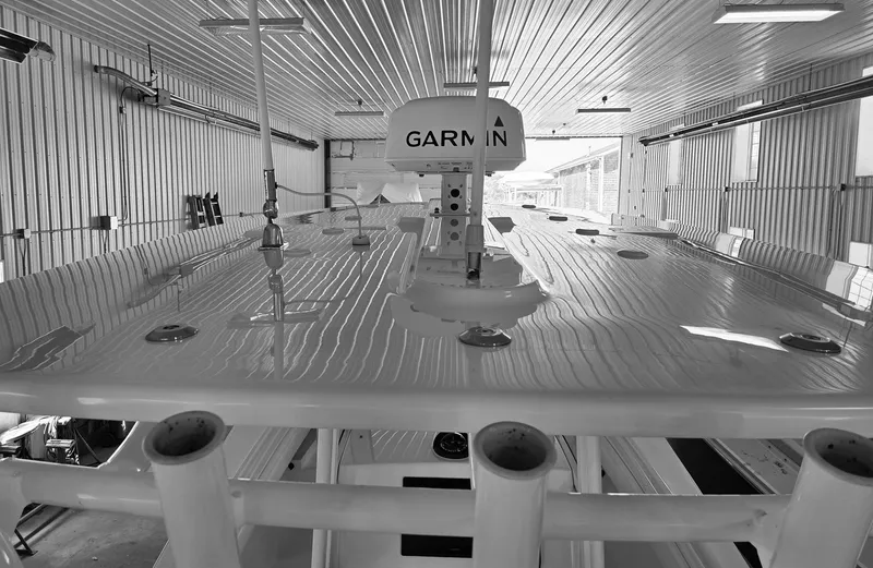 Slide: The Image of 2020 Regulator 25 boat in a garage, featuring Garmin equipment on the roof. - 12