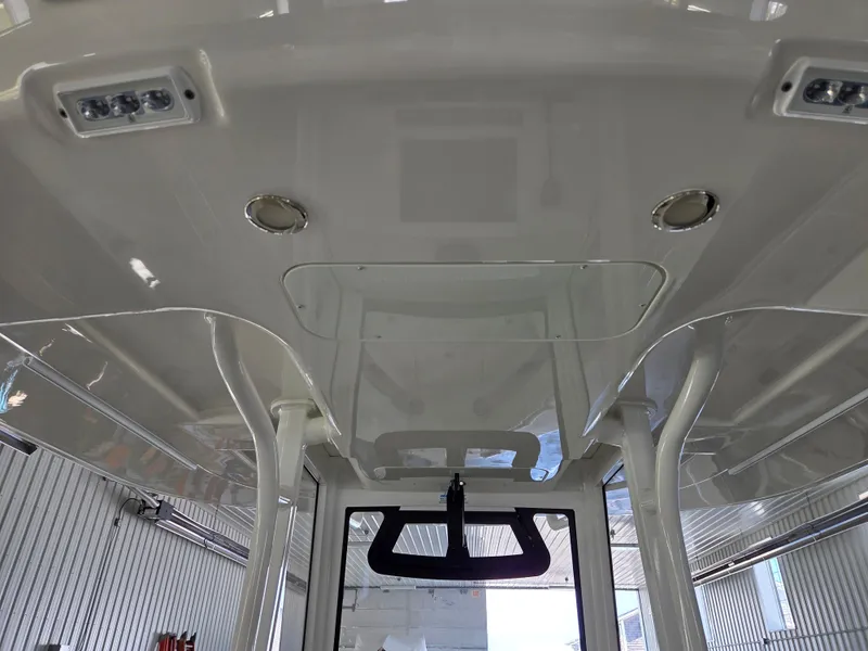 Slide: The Image of 2020 Regulator 25 boat interior ceiling with lights and structural details. - 13