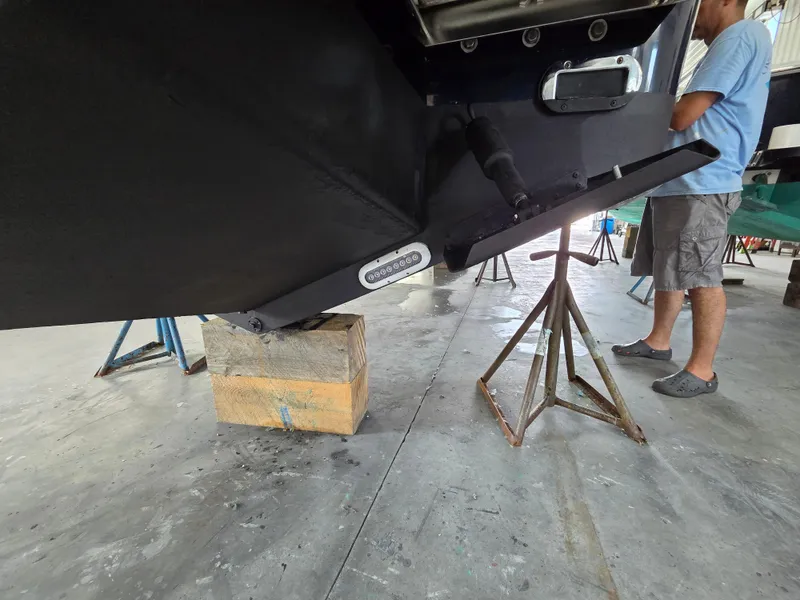 Slide: The Image of 2020 Regulator 25 boat on stands in a workshop, undergoing maintenance. - 14