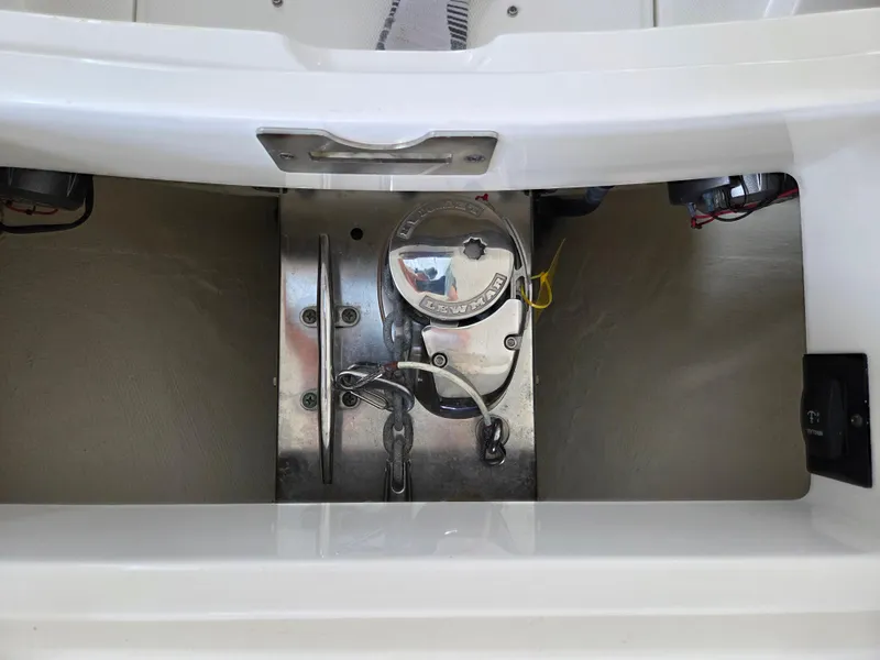 Slide: The Image of Anchor compartment of a 2020 Regulator 25 boat, featuring a windlass system. - 15