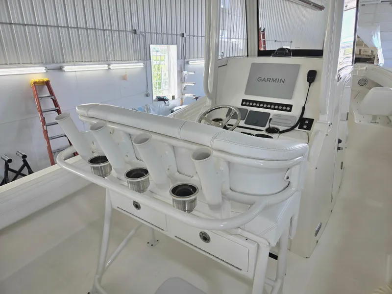 Slide: The Image of 2020 Regulator 25 boat interior with Garmin navigation system in a well-lit garage. - 3