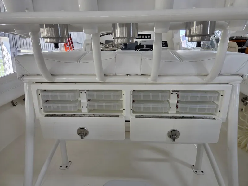 Slide: The Image of 2020 Regulator 25 boat storage compartments with rod holders and tackle boxes. - 4