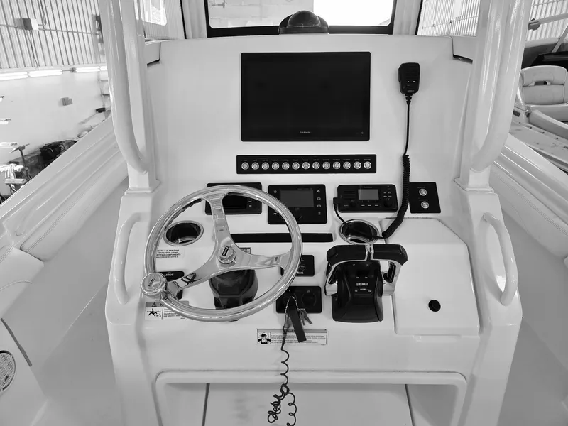 Slide: The Image of Control panel of a 2020 Regulator 25 boat with steering wheel and navigation equipment. - 6