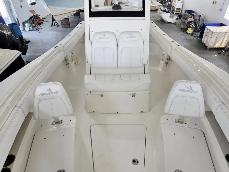 Slide: The Image of 2020 Regulator 25 boat interior with white seating and spacious deck. - 9