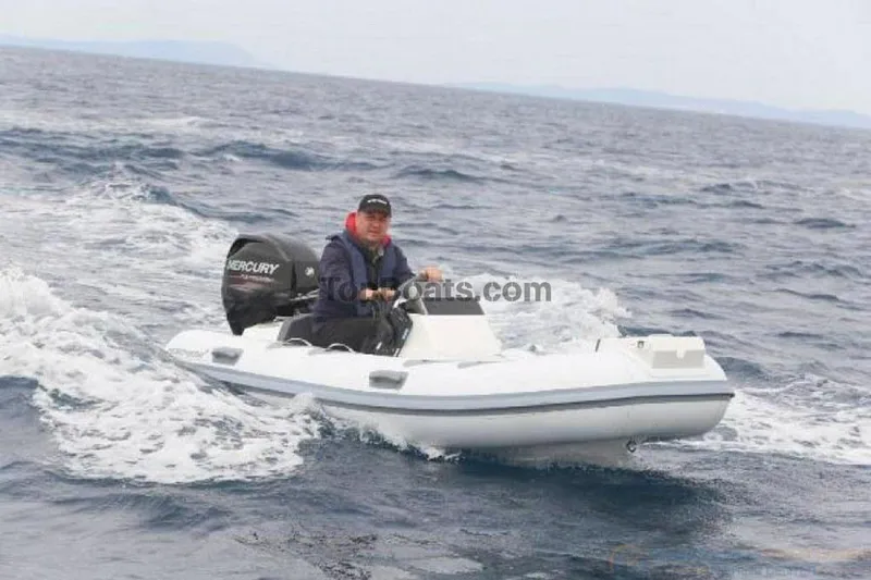 Slide: The Image of Man driving 2022 Northstar Axs 3.1 boat on open water. - 1