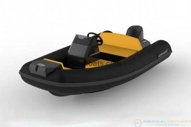 Slide: The Image of 2022 Northstar Axs 3.1 inflatable boat, black and yellow design, side view. - 6