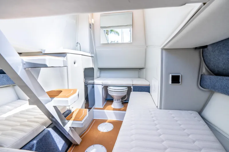 Slide: The Image of Interior of 2026 Novielli Veloche 349 boat, featuring compact cabin with seating and toilet. - 4