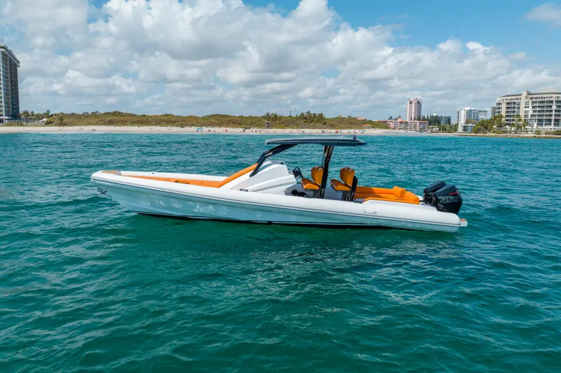Slide: The Image of 2026 Novielli Veloche 349 boat on blue ocean near sandy beach and cityscape. - 9