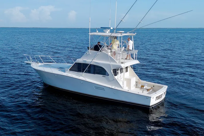 Slide: The Image of 1990 Post 44 Sport Fisherman boat on open water, featuring a sleek white design. - 12