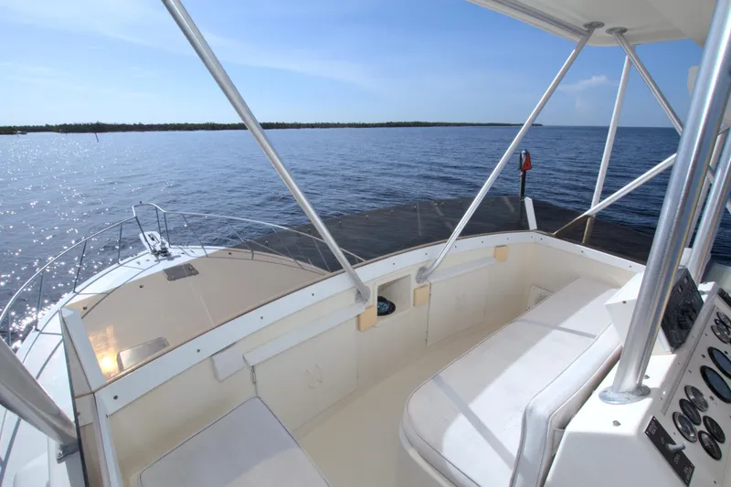 Slide: The Image of 1990 Post 44 Sport Fisherman boat cockpit with ocean view and clear blue sky. - 15
