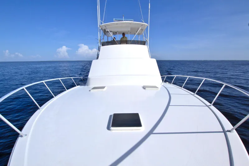 Slide: The Image of 1990 Post 44 Sport Fisherman yacht cruising on open sea under clear blue sky. - 28