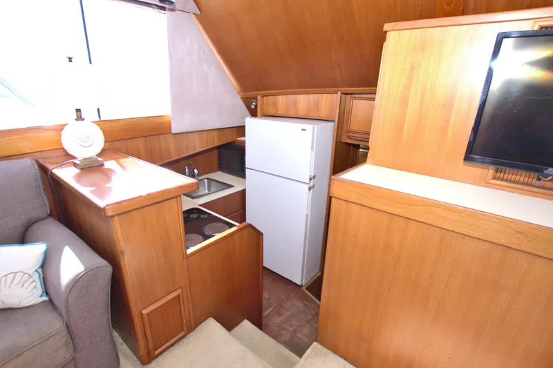 Slide: The Image of Interior of 1990 Post 44 Sport Fisherman yacht with kitchenette and seating area. - 38