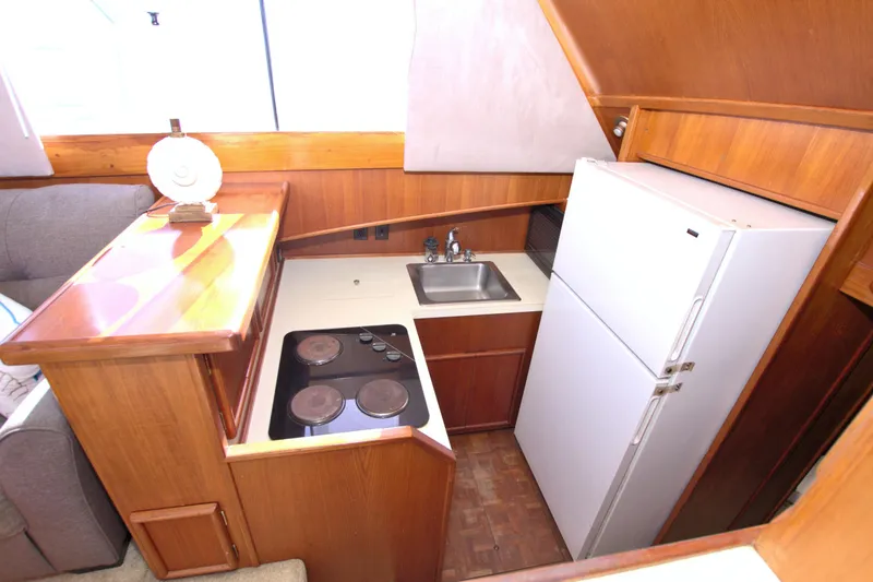Slide: The Image of Compact kitchen in 1990 Post 44 Sport Fisherman boat with stove, sink, and refrigerator. - 40