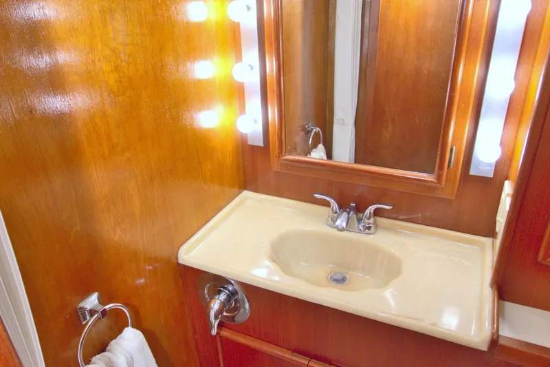 Slide: The Image of Bathroom vanity with mirror and lights on 1990 Post 44 Sport Fisherman yacht. - 43