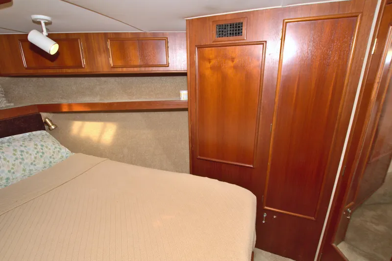 Slide: The Image of Cozy cabin interior of 1990 Post 44 Sport Fisherman with wood paneling and bed. - 49