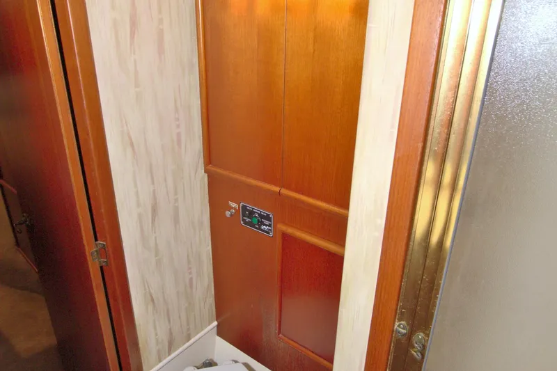 Slide: The Image of Interior of 1990 Post 44 Sport Fisherman, featuring wooden cabinetry and control panel. - 52