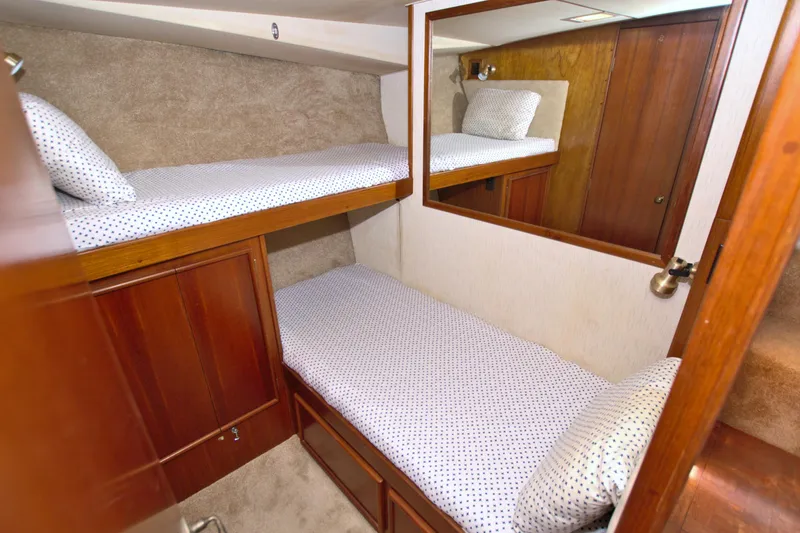 Slide: The Image of 1990 Post 44 Sport Fisherman cabin with bunk beds and wooden interior. - 59