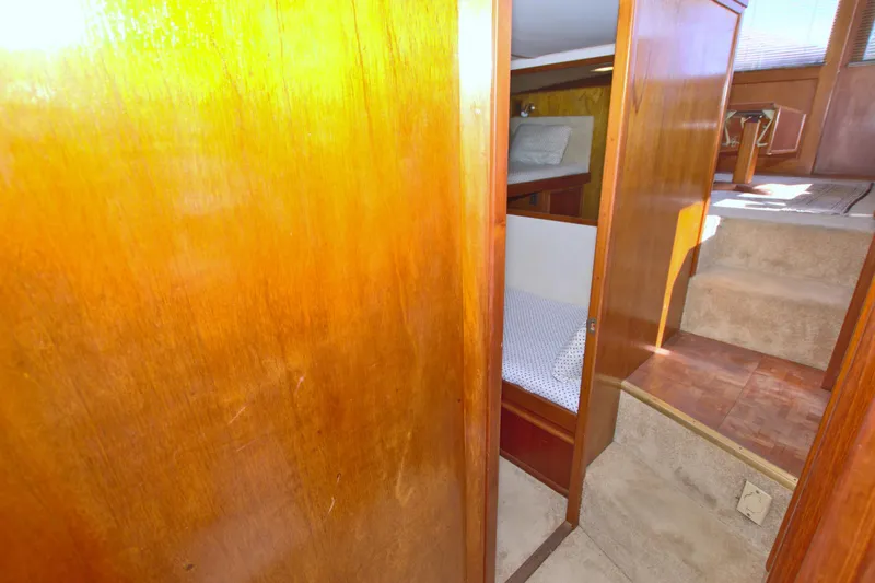 Slide: The Image of Interior of 1990 Post 44 Sport Fisherman yacht with wooden paneling and cozy sleeping area. - 61