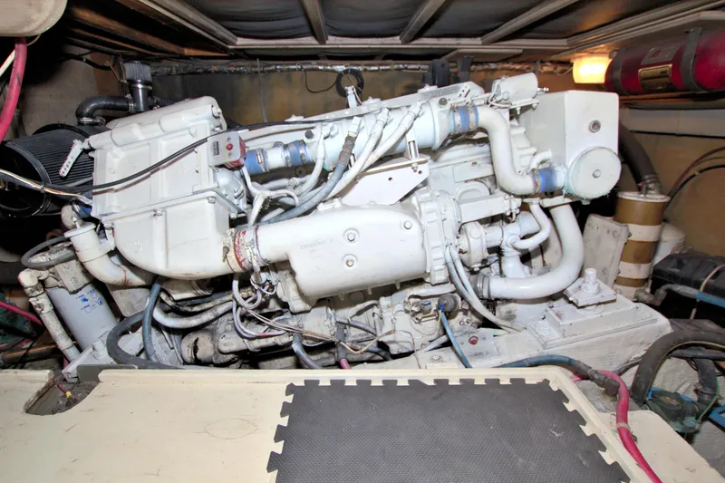 Slide: The Image of Engine room of 1990 Post 44 Sport Fisherman boat, showcasing detailed machinery. - 64