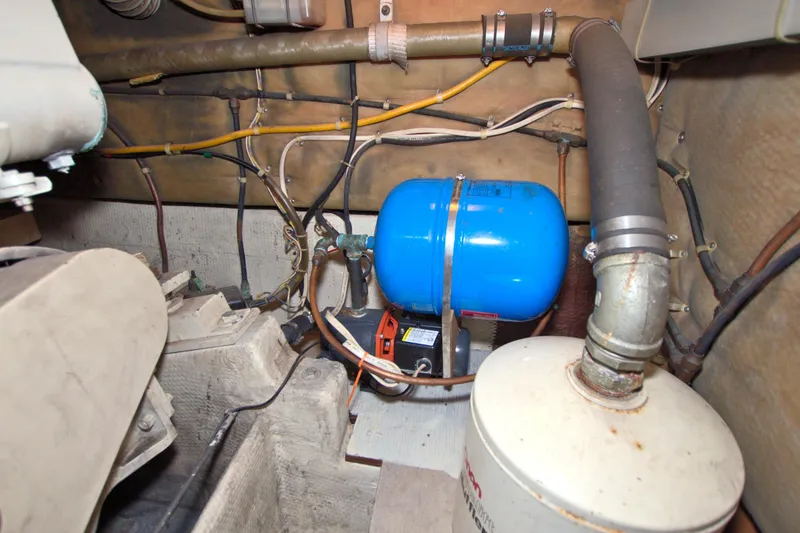 Slide: The Image of Engine room of 1990 Post 44 Sport Fisherman with blue tank and pipes. - 68