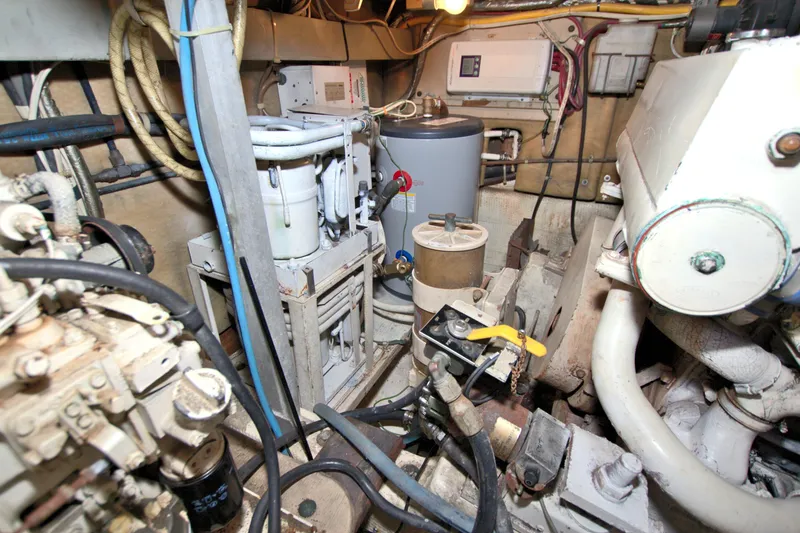 Slide: The Image of Engine room of a 1990 Post 44 Sport Fisherman boat, showcasing mechanical components and equipment. - 70