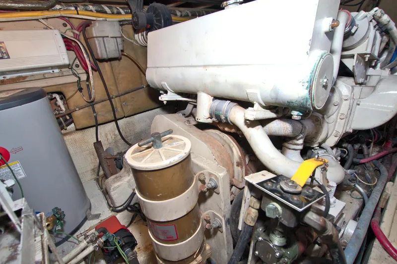Slide: The Image of Engine room of a 1990 Post 44 Sport Fisherman boat, showcasing mechanical components. - 71