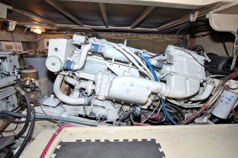 Slide: The Image of Engine room of a 1990 Post 44 Sport Fisherman boat, showcasing mechanical components. - 72