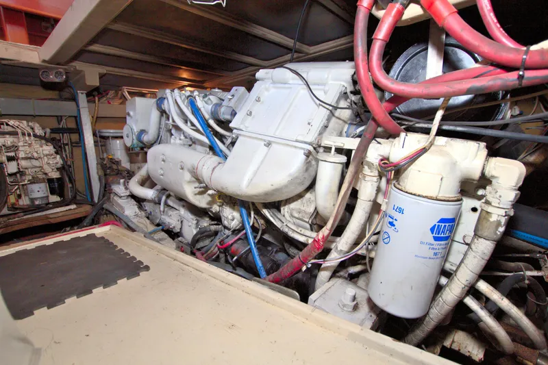 Slide: The Image of Engine room of 1990 Post 44 Sport Fisherman boat, showcasing machinery and components. - 73