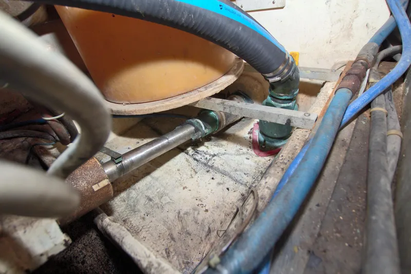 Slide: The Image of Engine compartment of a 1990 Post 44 Sport Fisherman boat, showing pipes and hoses. - 76