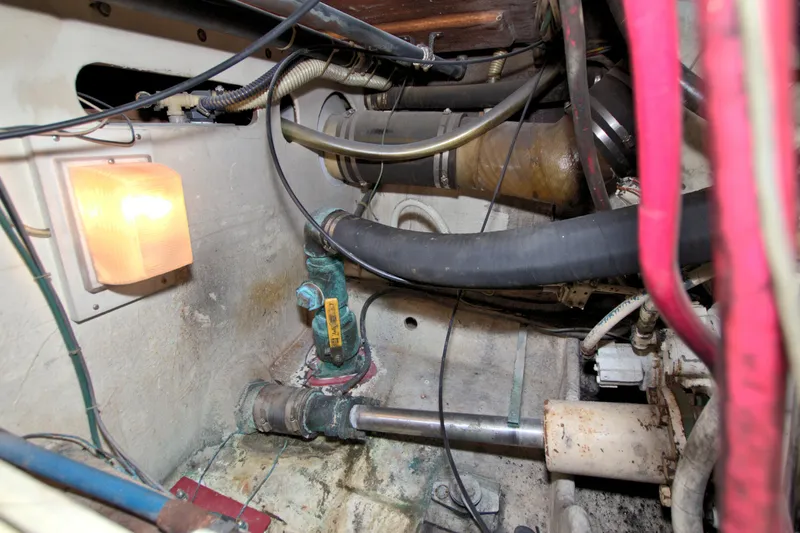 Slide: The Image of Engine room of 1990 Post 44 Sport Fisherman with visible pipes and wiring. - 78