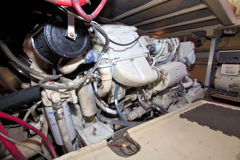 Slide: The Image of Engine room of a 1990 Post 44 Sport Fisherman boat, showcasing complex machinery. - 79